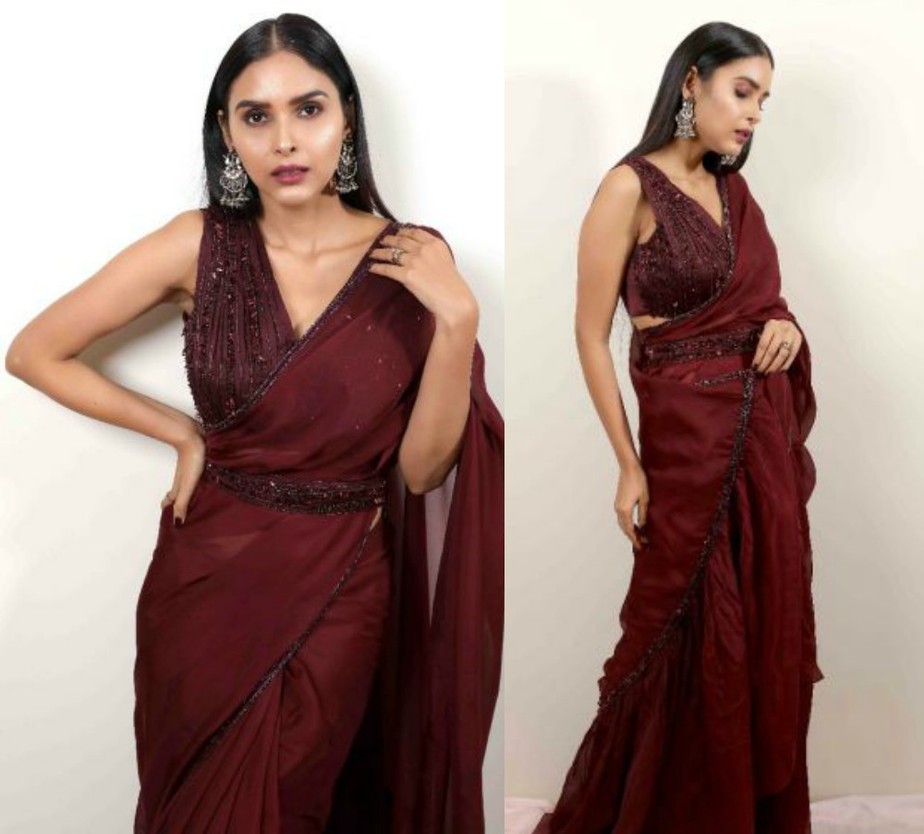 saree in wine colour and embroidered sleeveless blouse