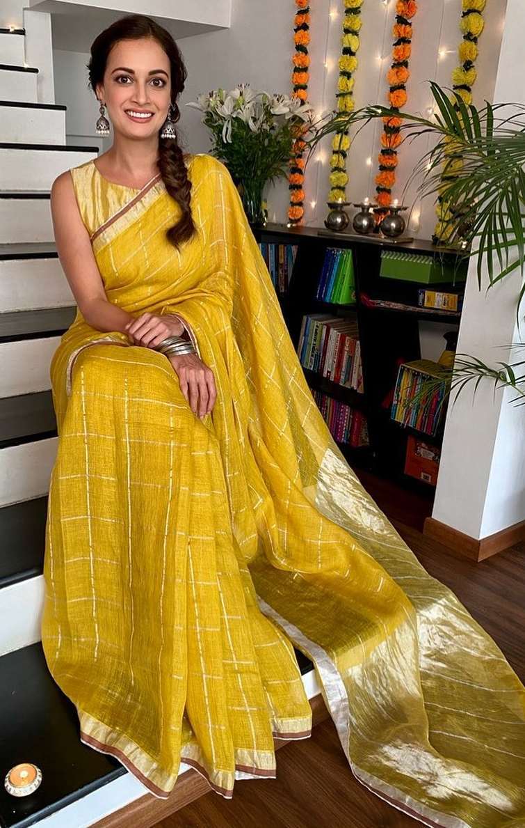 Dia Mirza is a lighted diya in a yellow saree and golden blouse by Anavila