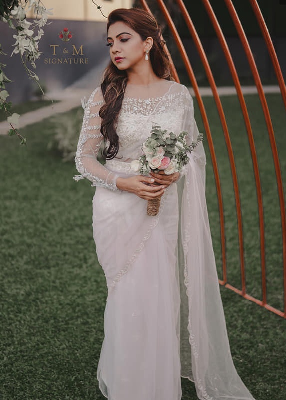 madonna sebastian in a white bridal saree