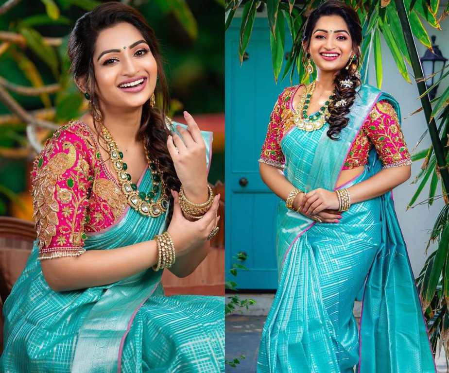 nakshatra nagesh in a blue silk saree and pink blouse