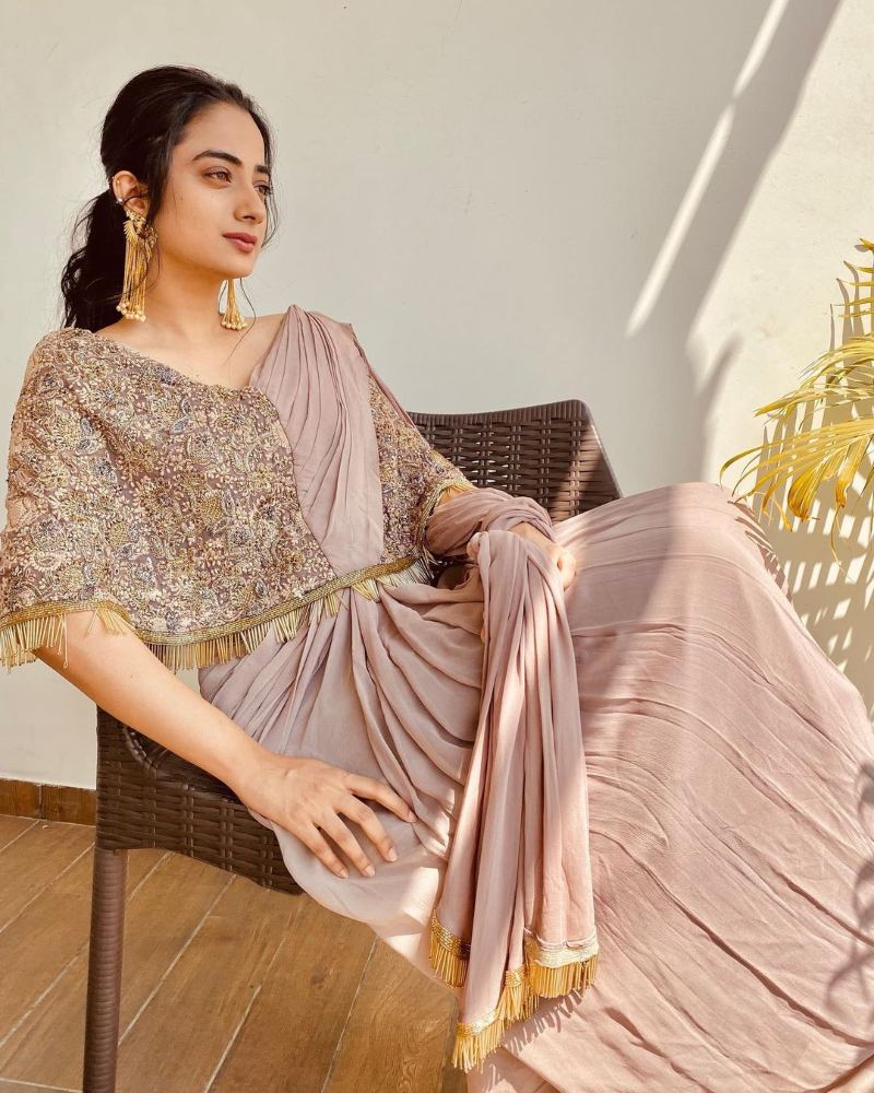 namitha pramod in a beige predraped saree gown with cape