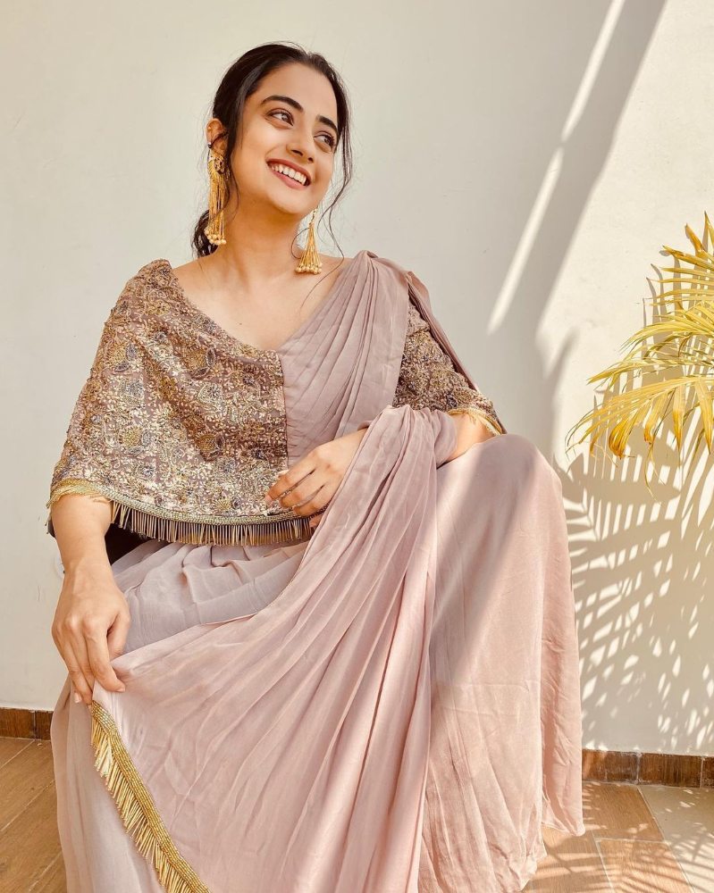 namitha pramod in a beige saree gown with brown cape