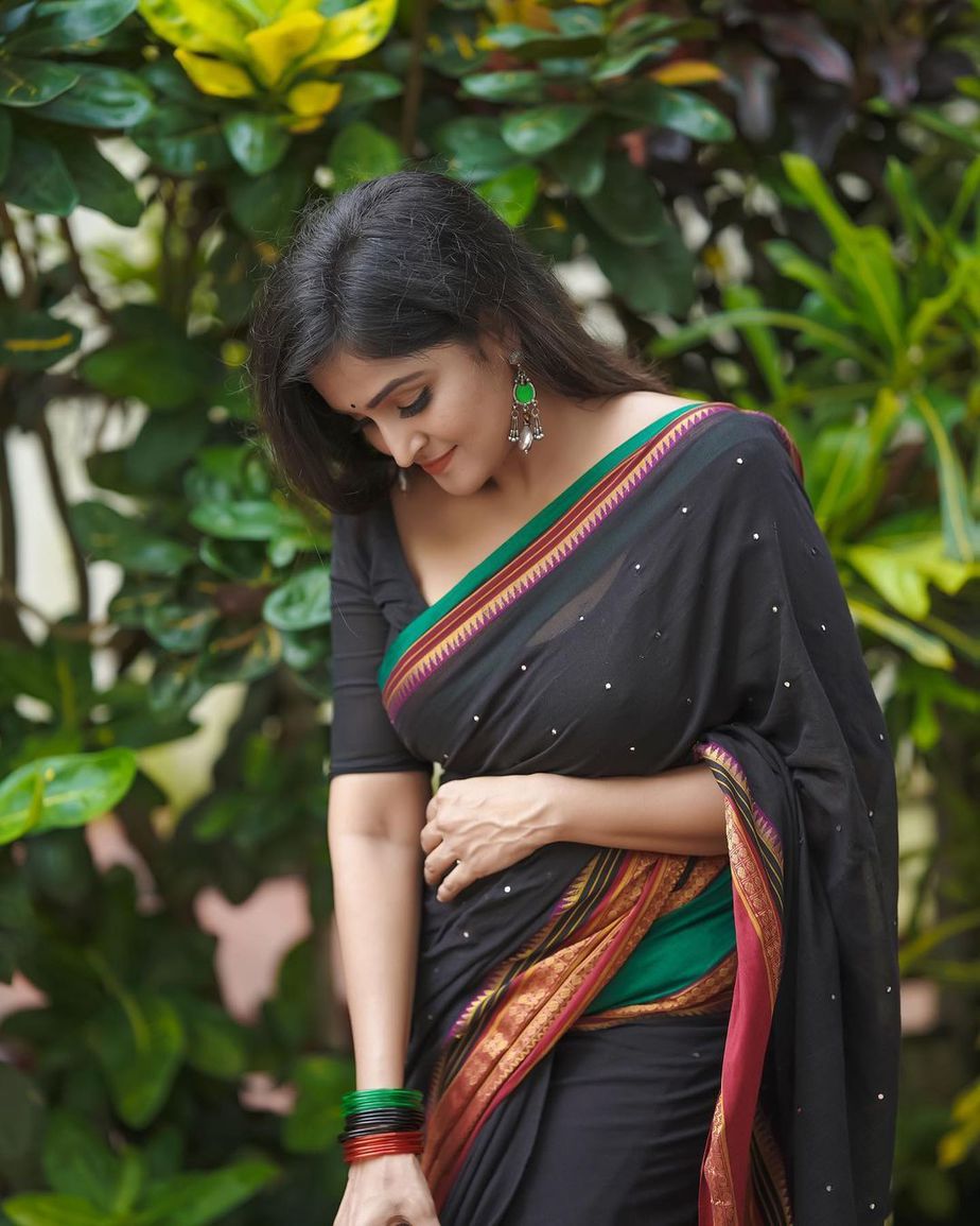 Ramya Nambessan S Traditional Look In A Black Mirror Work Saree