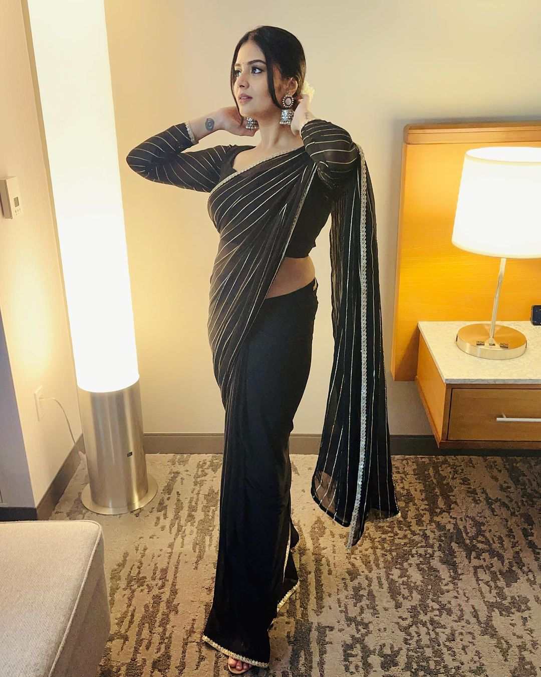 Sreemukhi looks beautiful in a black striped saree!
